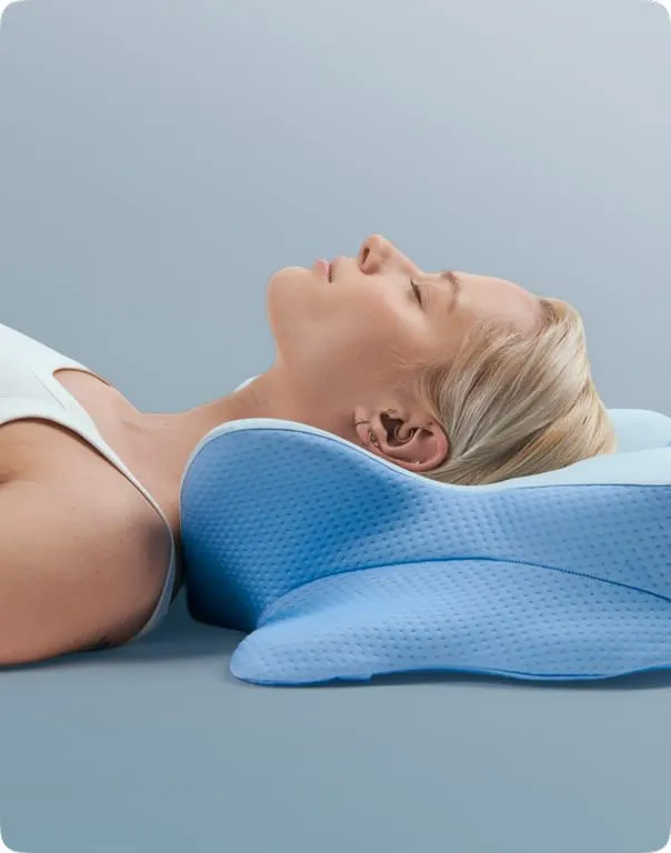 Woman sleeping comfortably on the Derila Ergo blue butterfly memory foam pillow for neck and spine alignment